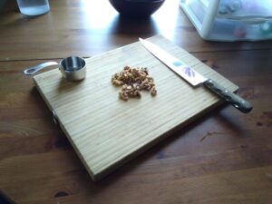 chopping walnuts for baked pears and honey