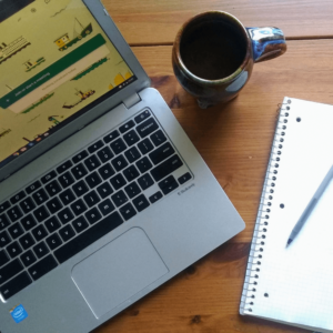 An image of a computer with Google meet up, a coffee cup, and a notebook for virtual appointments. Virtual appointments are great for fertility or infertility concerns, prenatal discomfort, birth preparation, postpartum recovery, and more